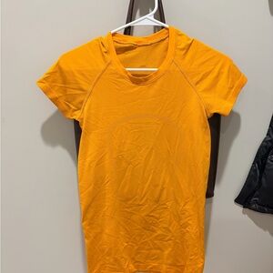 lululemon athletica Bright Orange Short Sleeve Swiftly Tech
Hip length